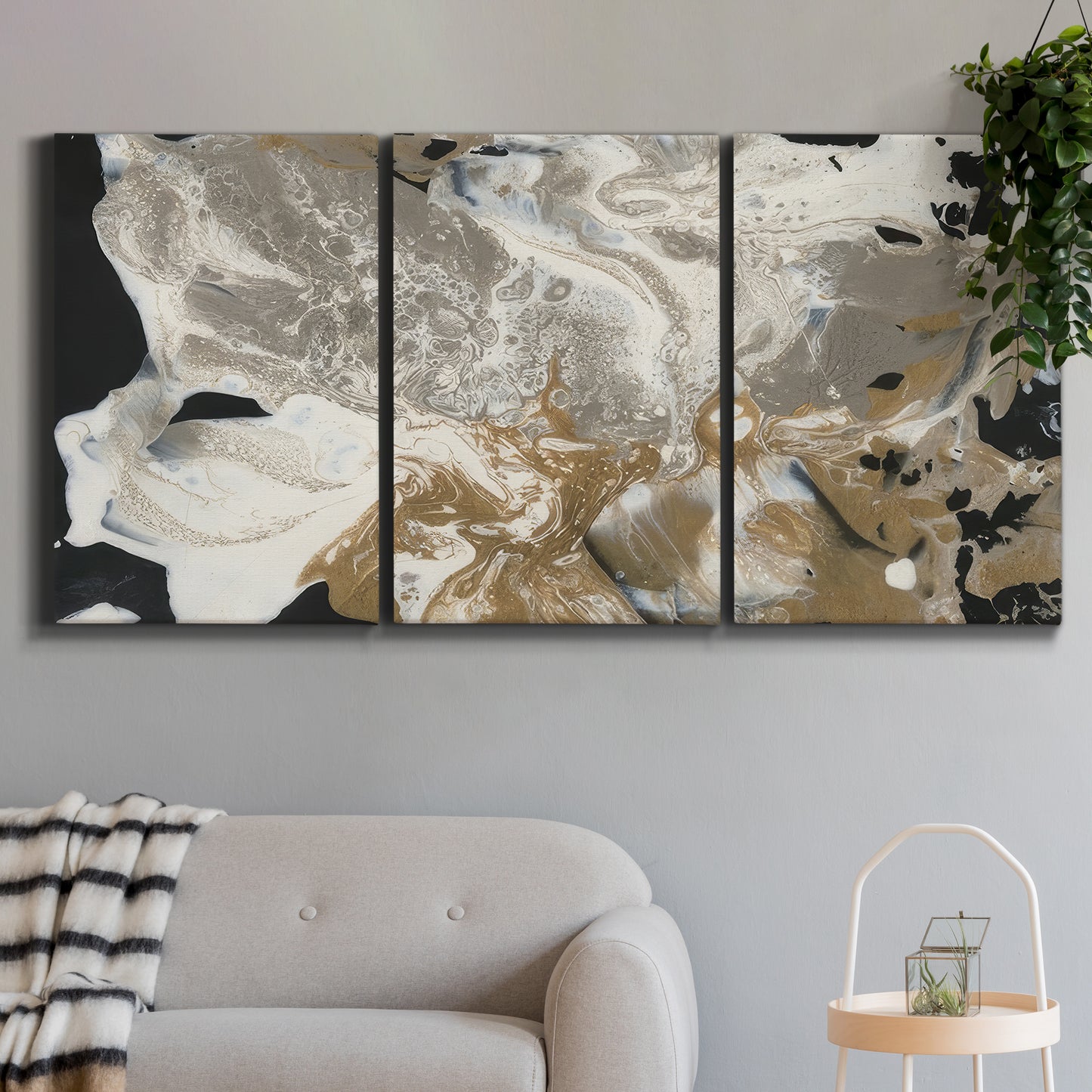 Three-panel canvas wall art featuring pale abstract mask like forms, displayed in a modern living room above a sofa.
