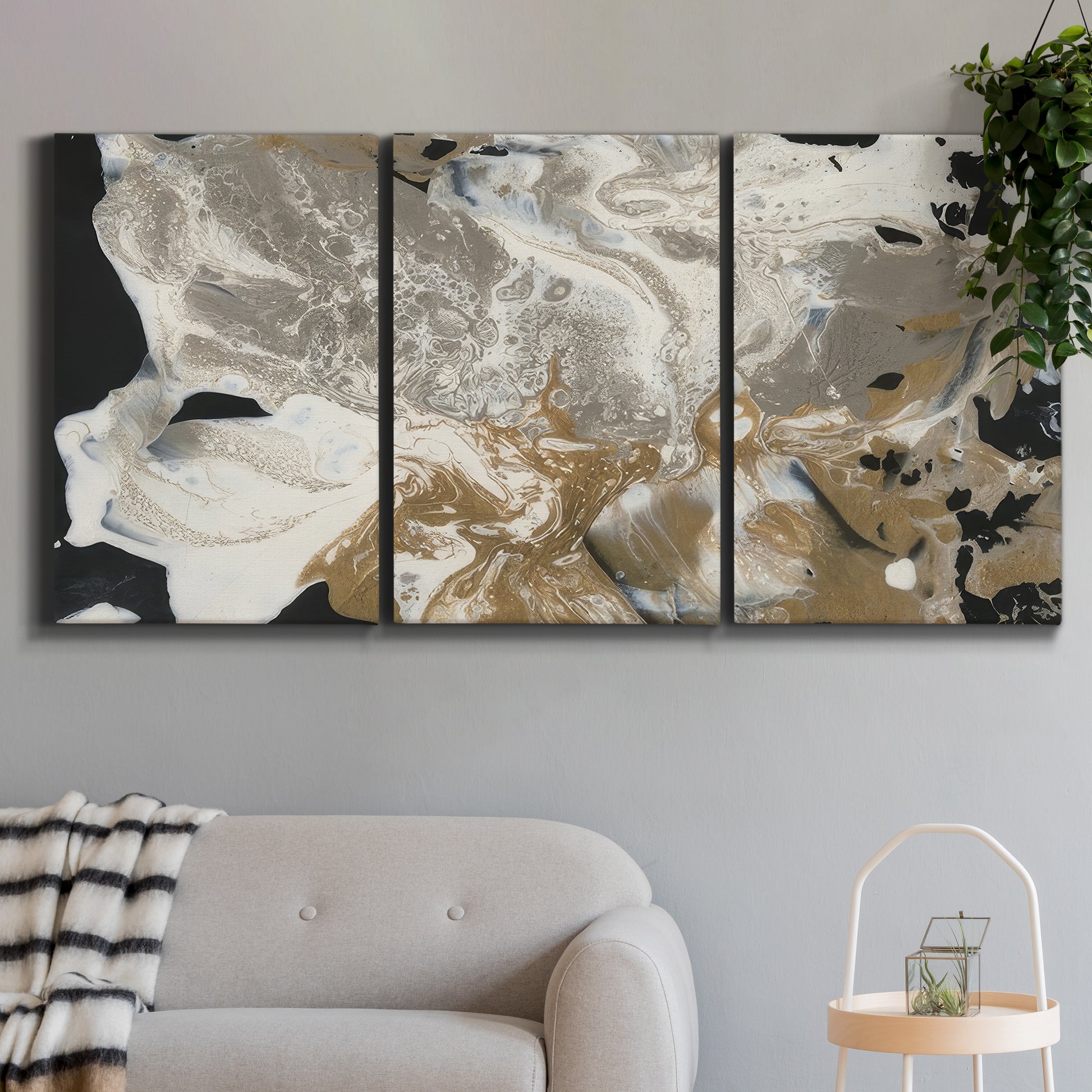 Three-panel canvas wall art featuring pale abstract mask like forms, displayed in a modern living room above a sofa.