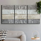 Three-panel canvas wall art featuring beach themed typography design, displayed in a modern living room above a sofa.