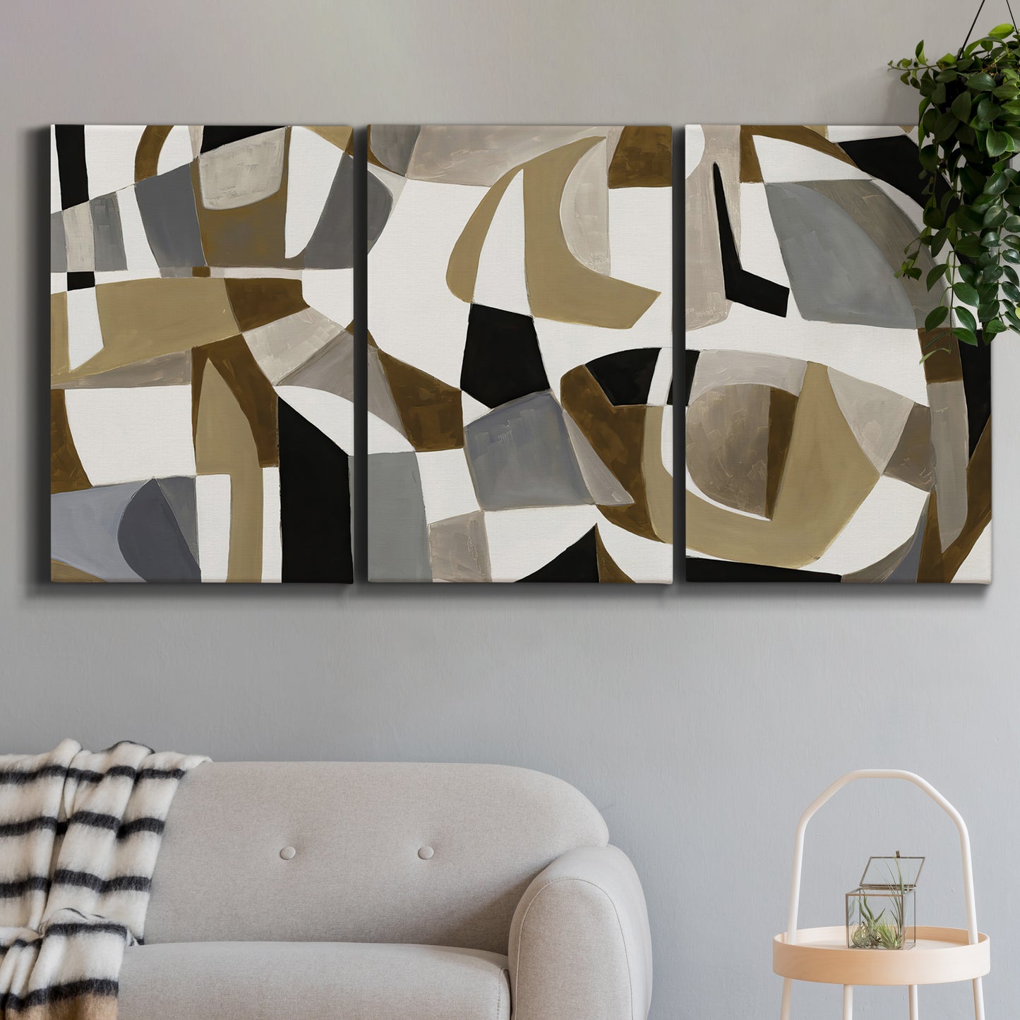 Three-panel canvas wall art featuring overlapping mid century geometric shapes, displayed in a modern living room above a sofa.