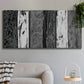 Three-panel canvas wall art featuring brushed metallic abstract textures, displayed in a modern living room above a sofa.