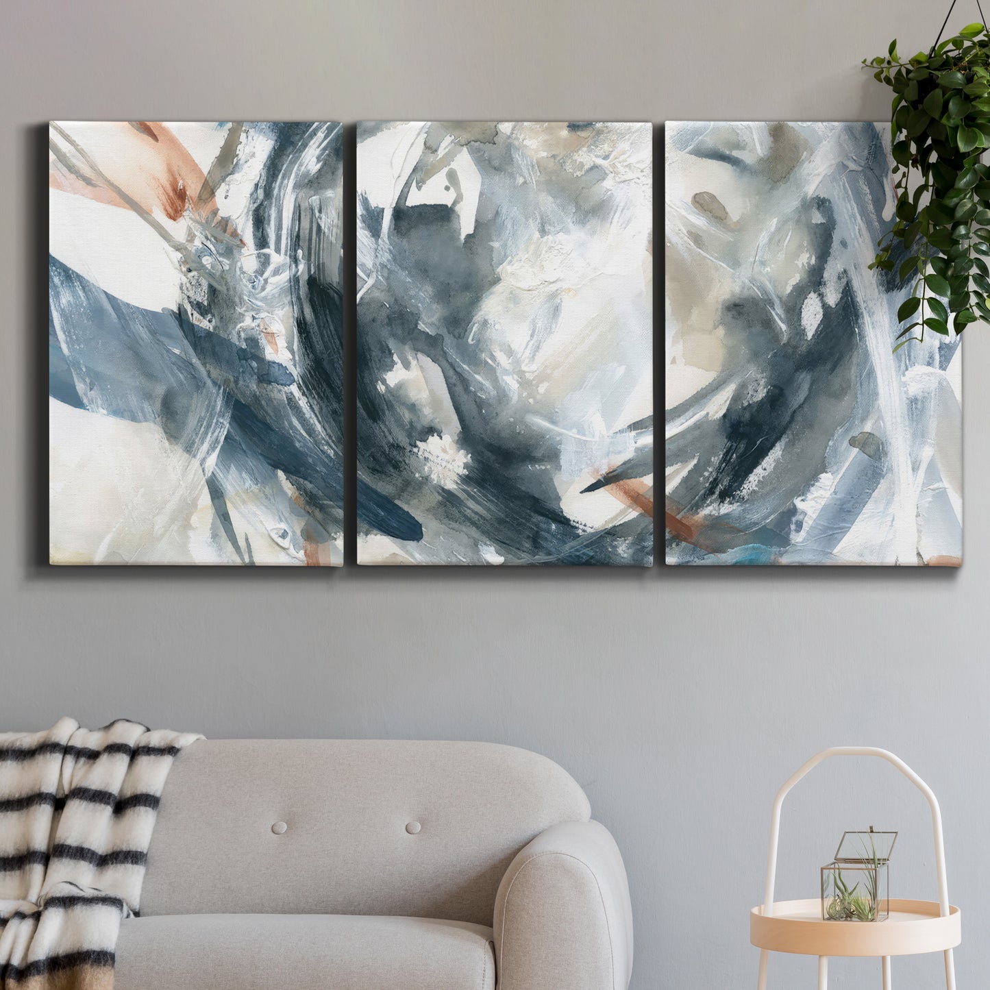 Three-panel canvas wall art featuring repeating abstract geometric array, displayed in a modern living room above a sofa.