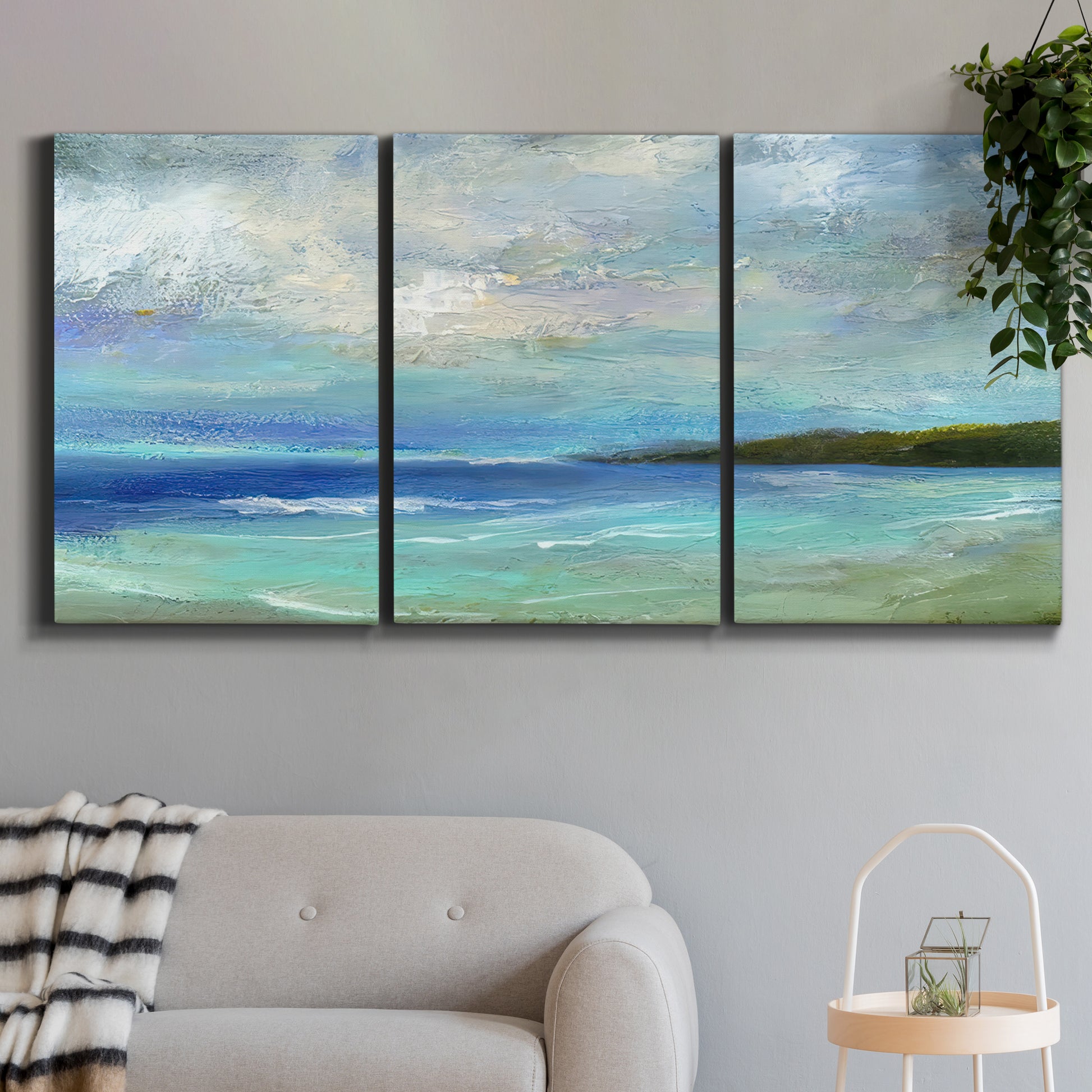 Three-panel canvas wall art featuring narrow island inlet waters, displayed in a modern living room above a sofa.