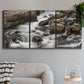 Three-panel canvas wall art featuring rushing river water over rocks, displayed in a modern living room above a sofa.