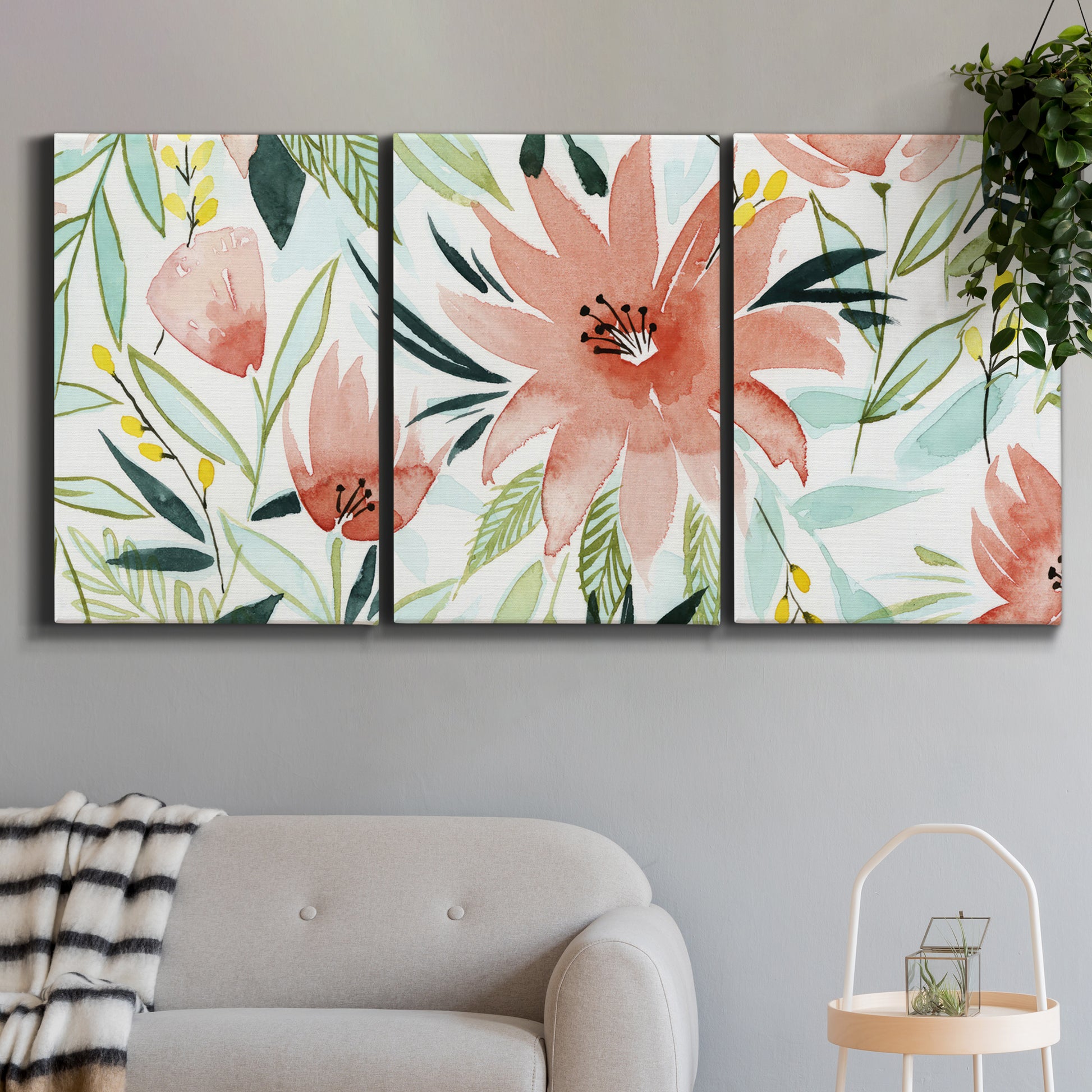 Three-panel canvas wall art featuring tropical botanical collage, displayed in a modern living room above a sofa.