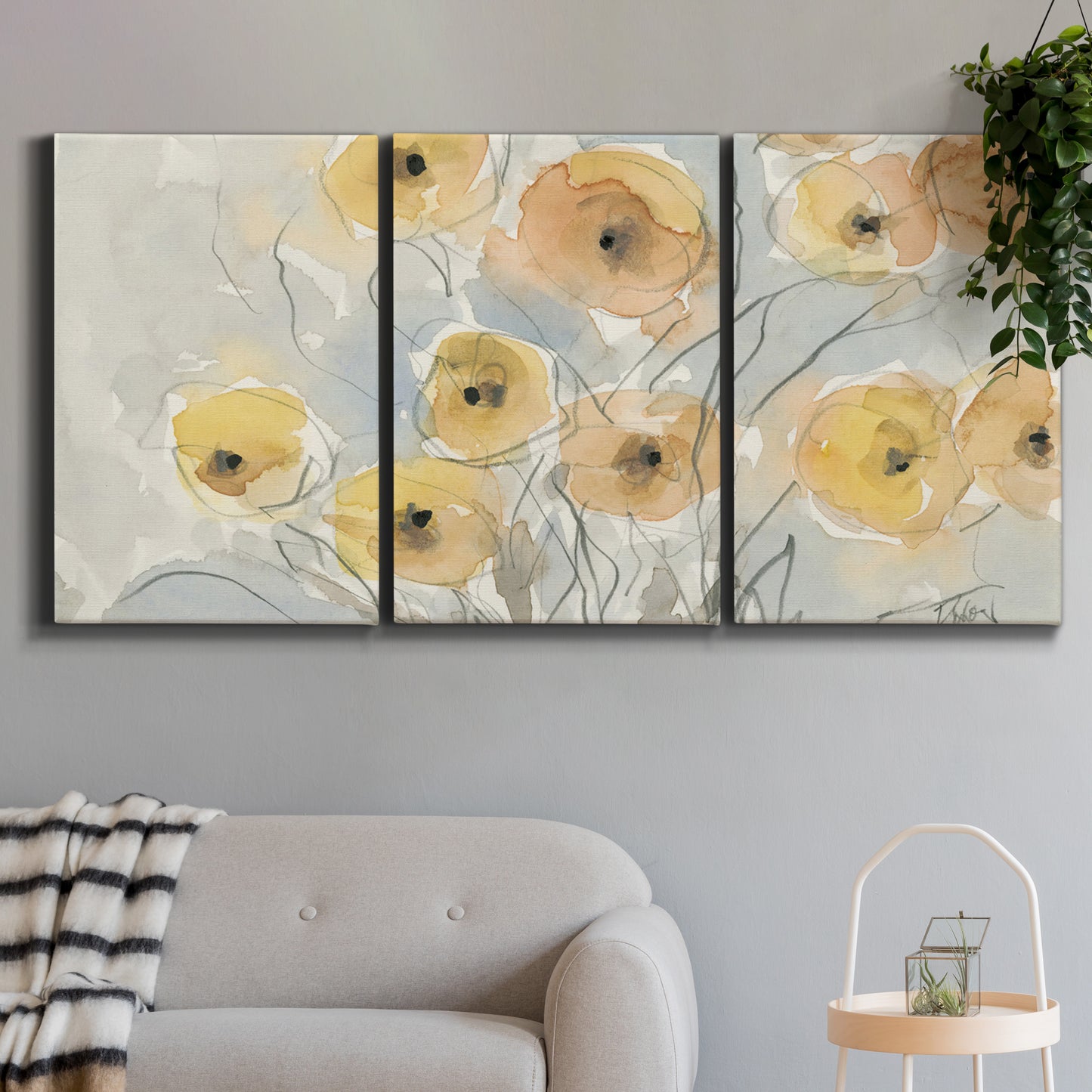 Three-panel canvas wall art featuring minimalist poppies at sunset, displayed in a modern living room above a sofa.