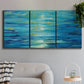 Three-panel canvas wall art featuring deep blue ocean water abstraction, displayed in a modern living room above a sofa.