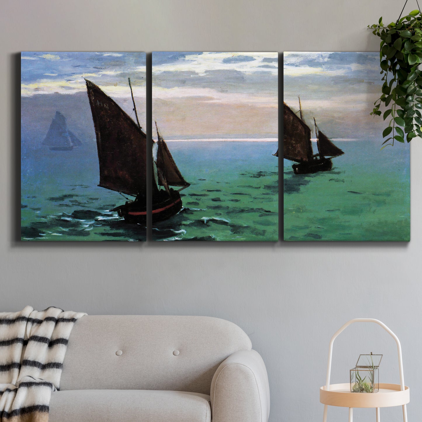 Three-panel canvas wall art featuring fishing boats moving through open sea, displayed in a modern living room above a sofa.
