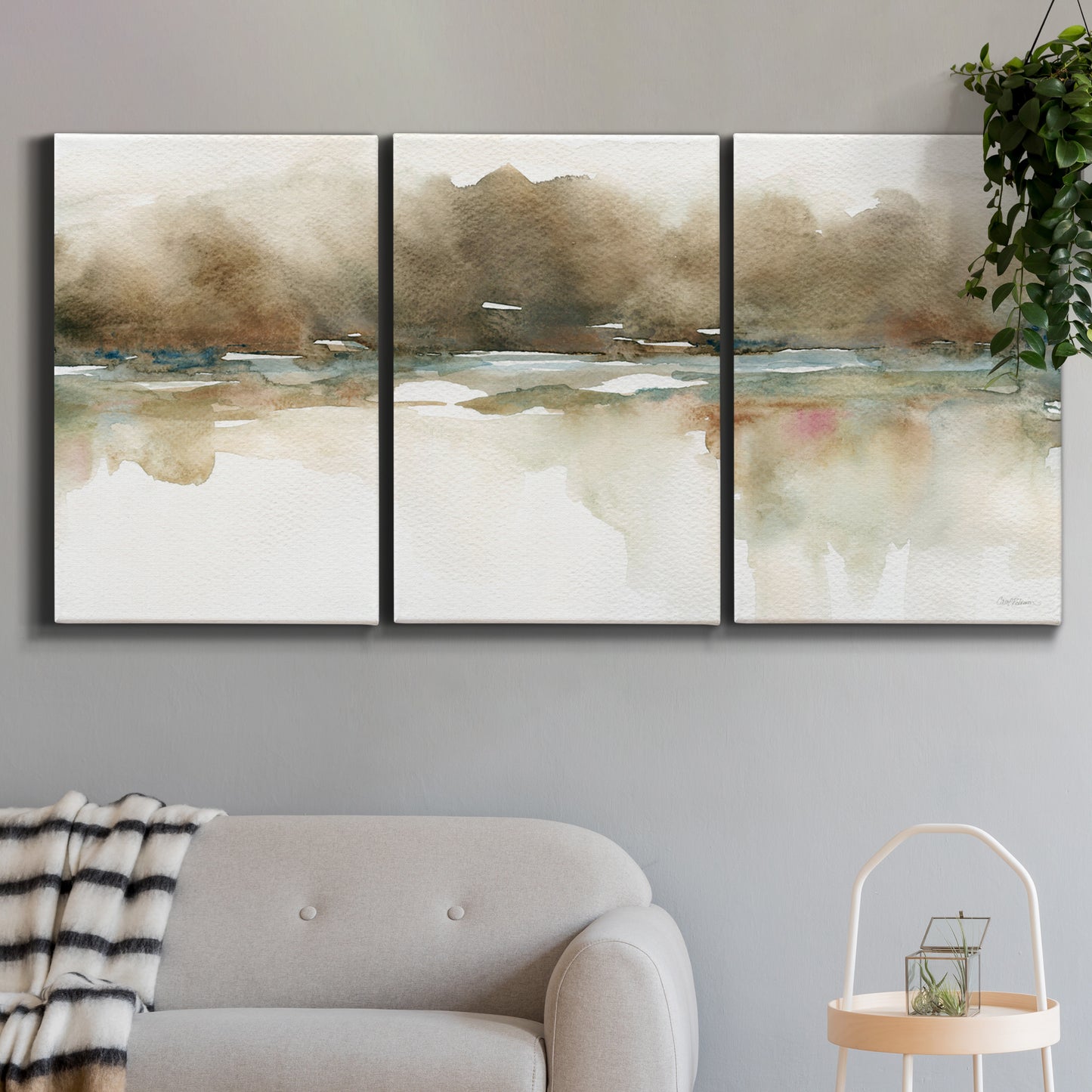 Three-panel canvas wall art featuring soft abstract mirrored reflections, displayed in a modern living room above a sofa.
