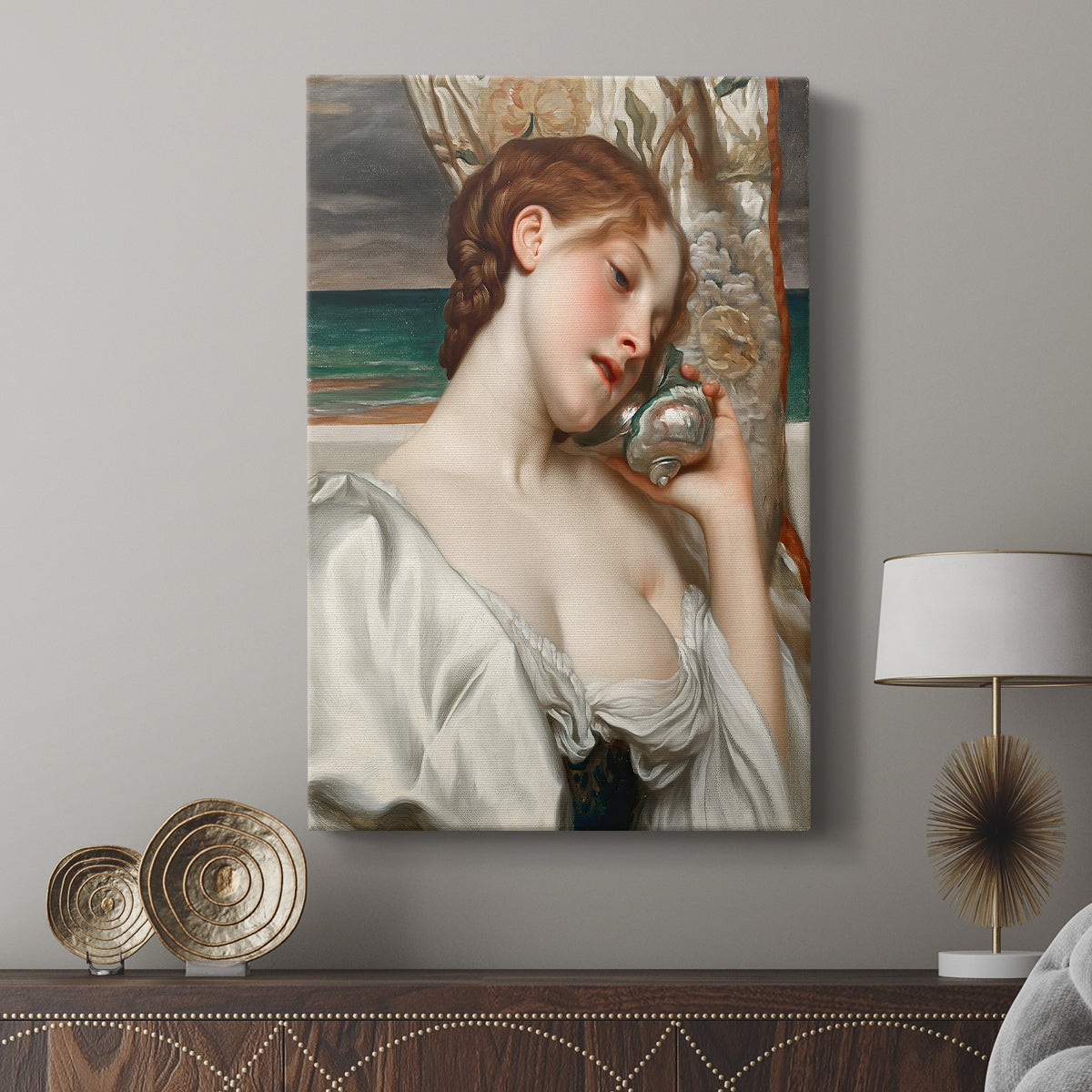 Canvas art print featuring a serene composition with a woman by the shoreline displayed in a modern interior space.