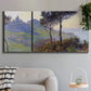 Three-panel canvas wall art featuring village church at sunset, displayed in a modern living room above a sofa.