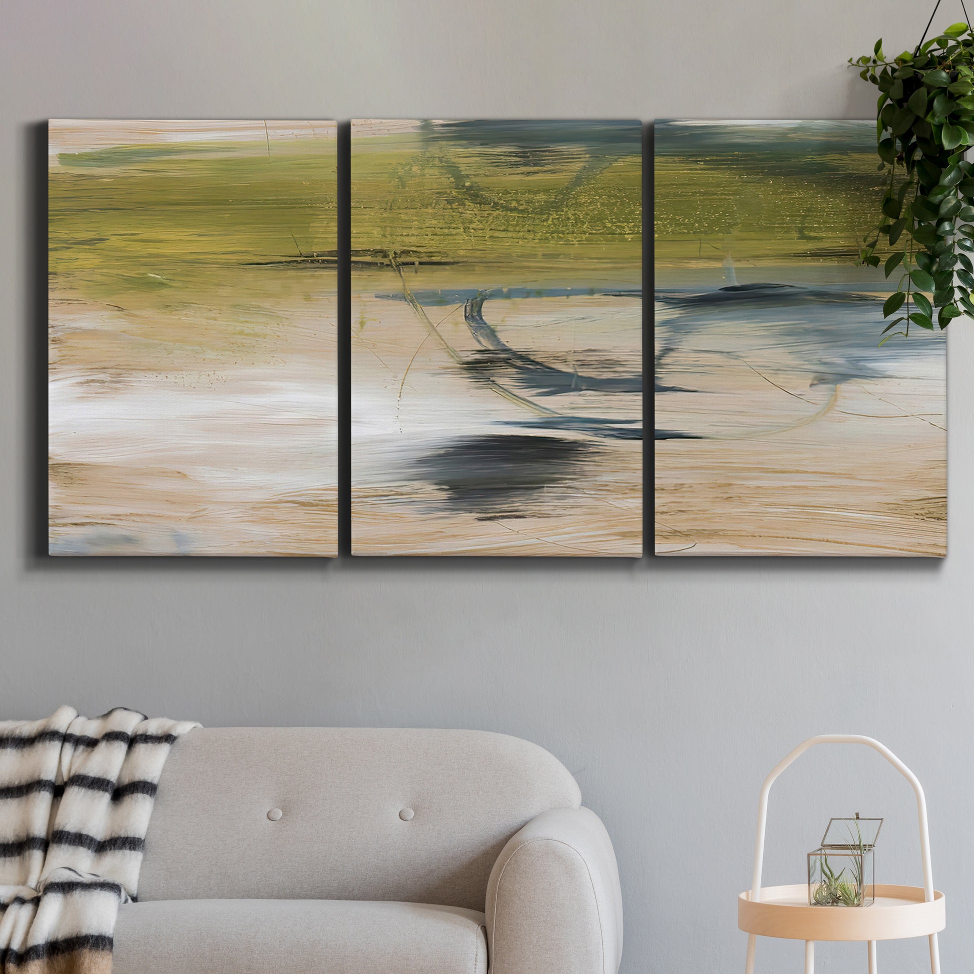 Three-panel canvas wall art featuring minimal abstract water reflections, displayed in a modern living room above a sofa.