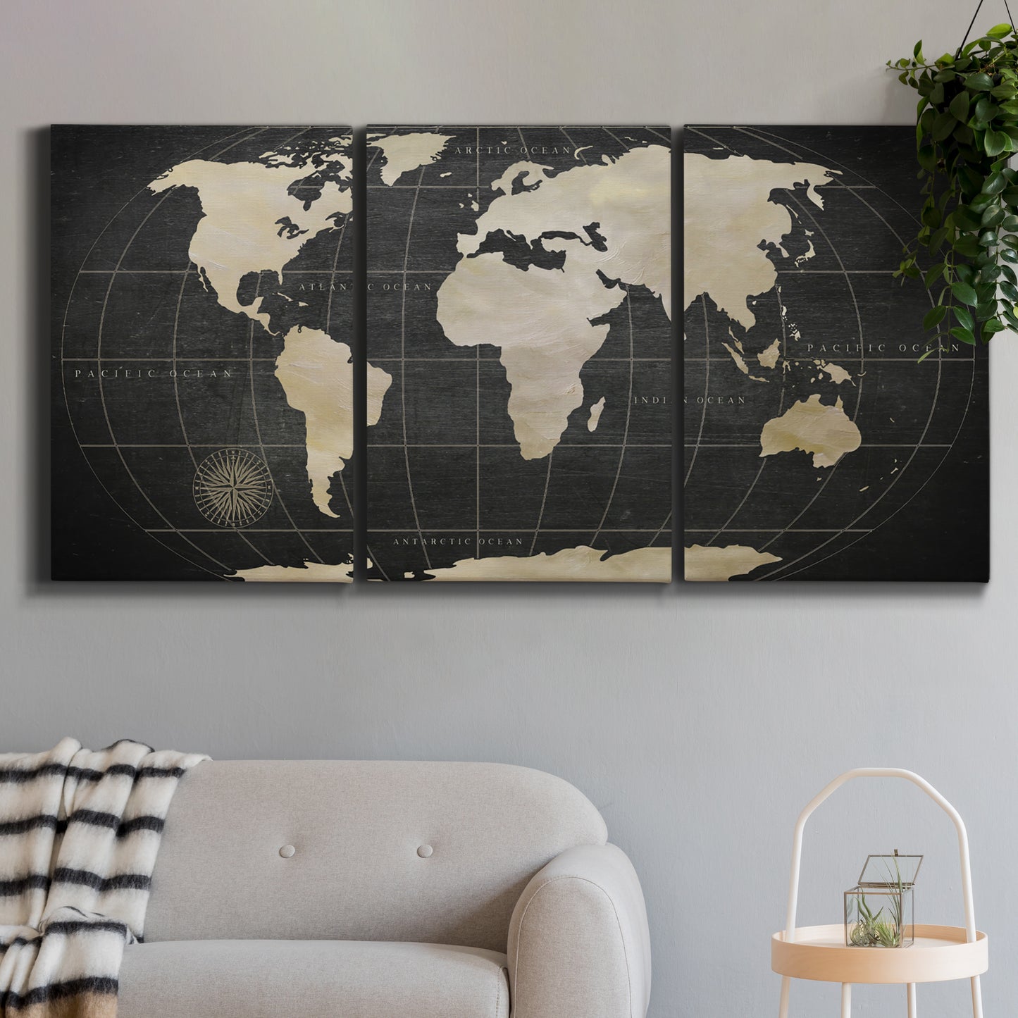 Three-panel canvas wall art featuring antique world map illustration, displayed in a modern living room above a sofa.