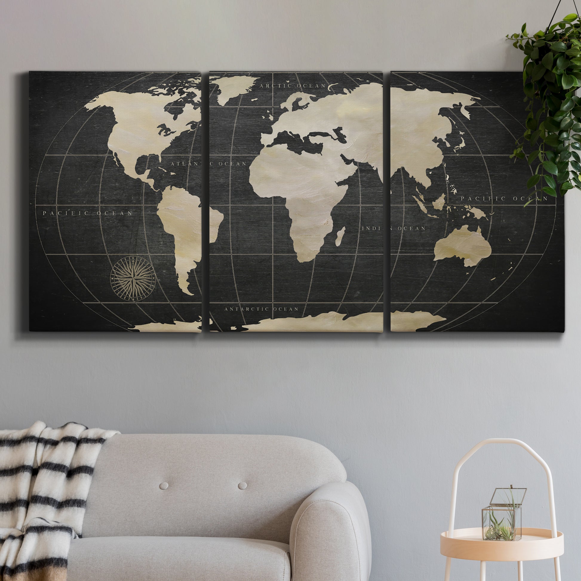 Three-panel canvas wall art featuring antique world map illustration, displayed in a modern living room above a sofa.