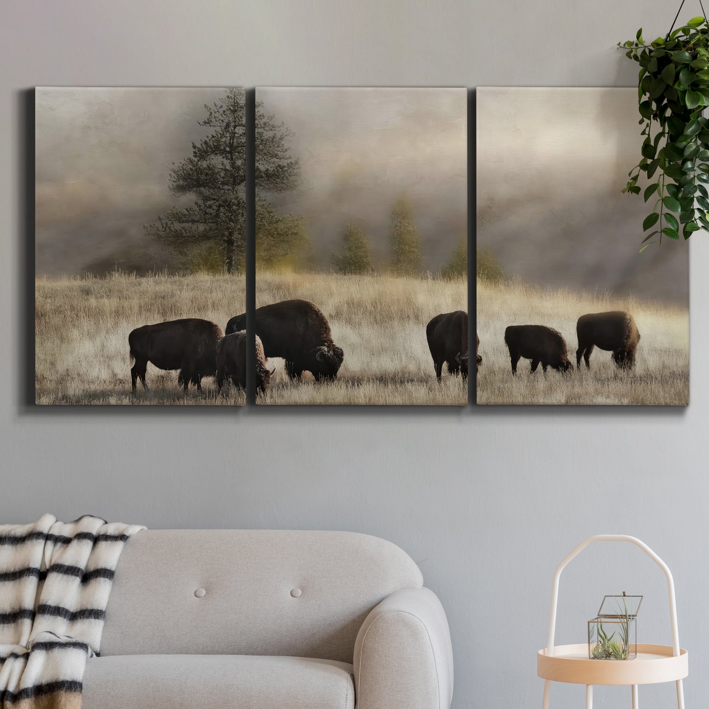 Three-panel canvas wall art featuring cattle grazing along ridge line, displayed in a modern living room above a sofa.