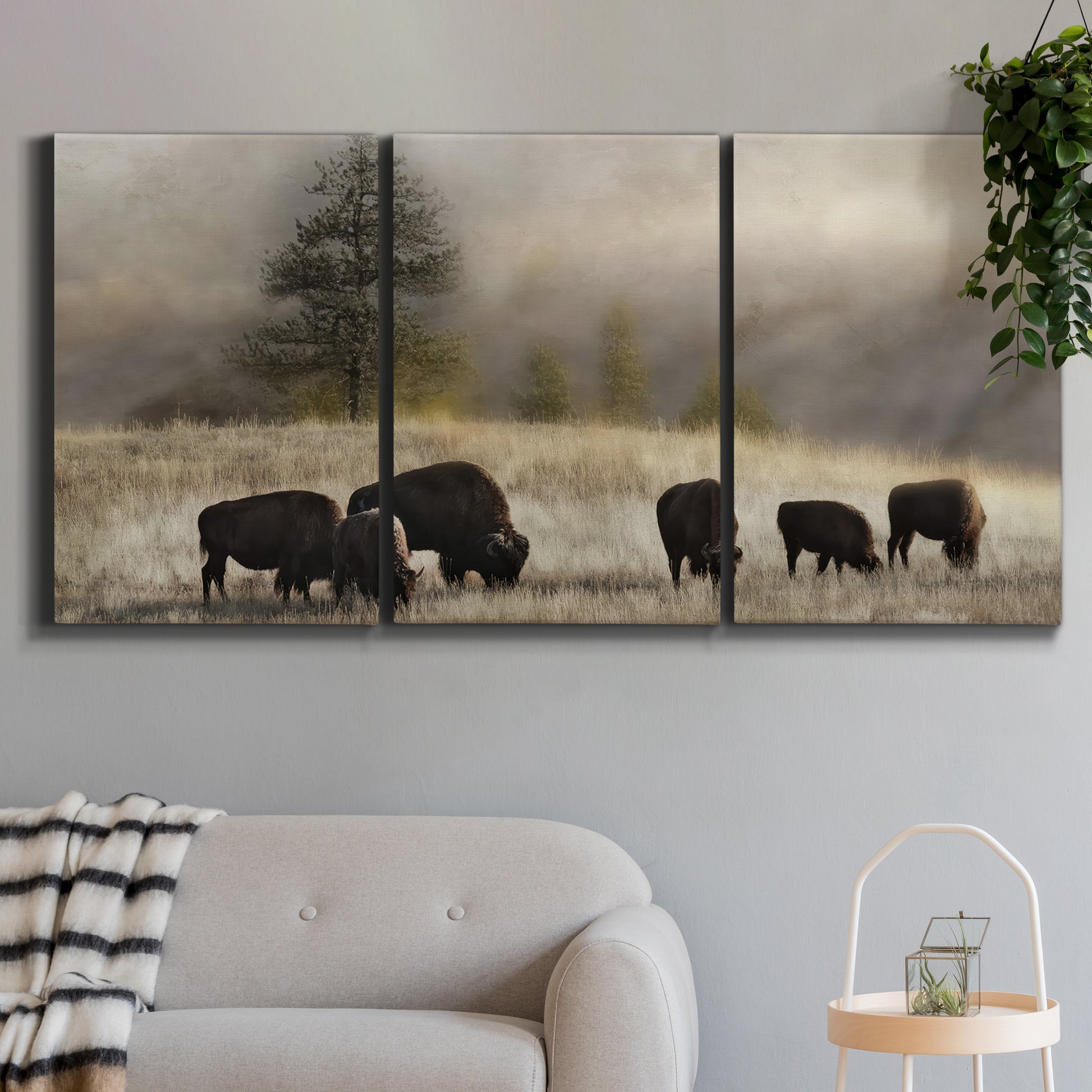 Three-panel canvas wall art featuring cattle grazing along ridge line, displayed in a modern living room above a sofa.
