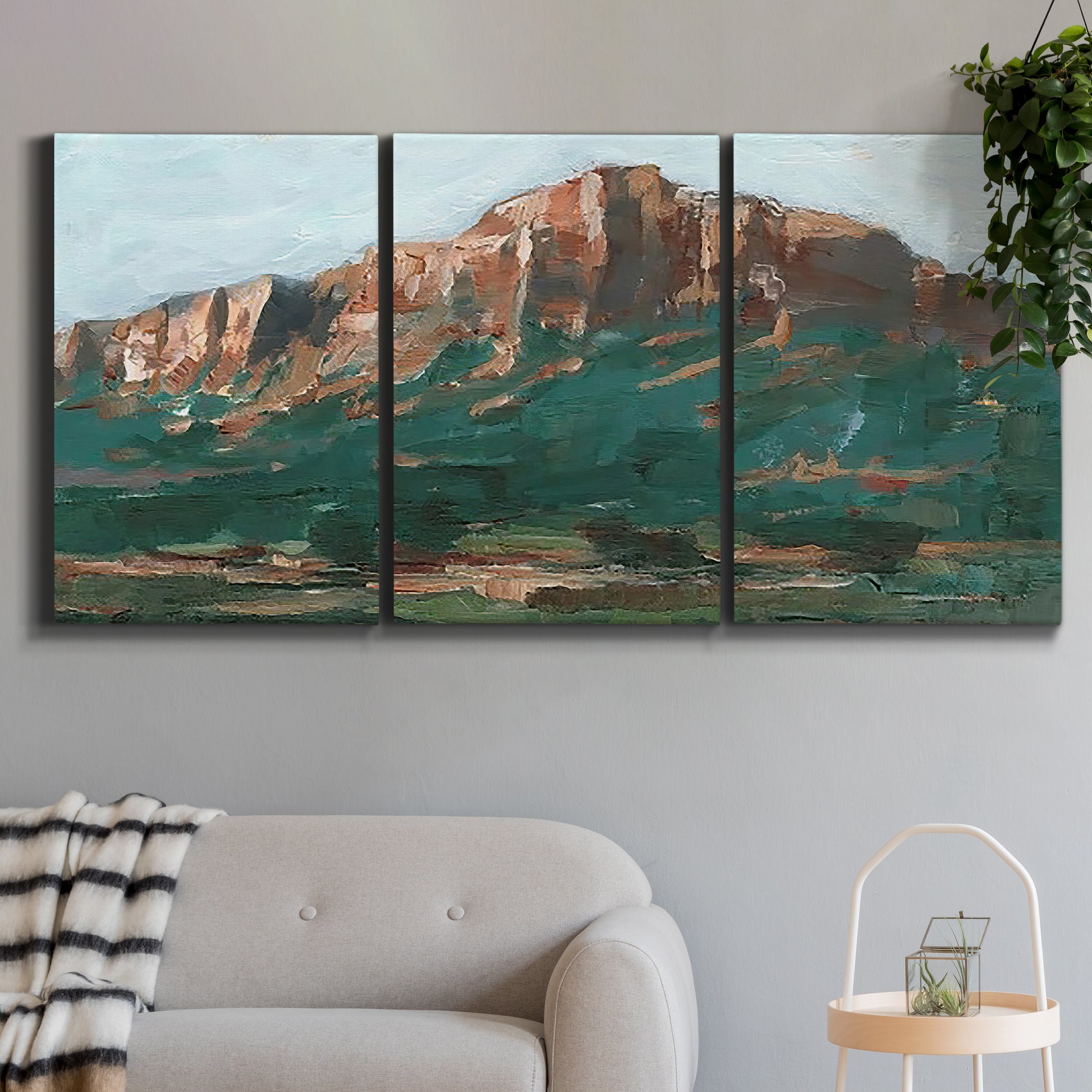 Three-panel canvas wall art featuring western landscape stretching into distance, displayed in a modern living room above a sofa.