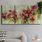 Three-panel canvas wall art featuring colorful floral garden composition, displayed in a modern living room above a sofa.