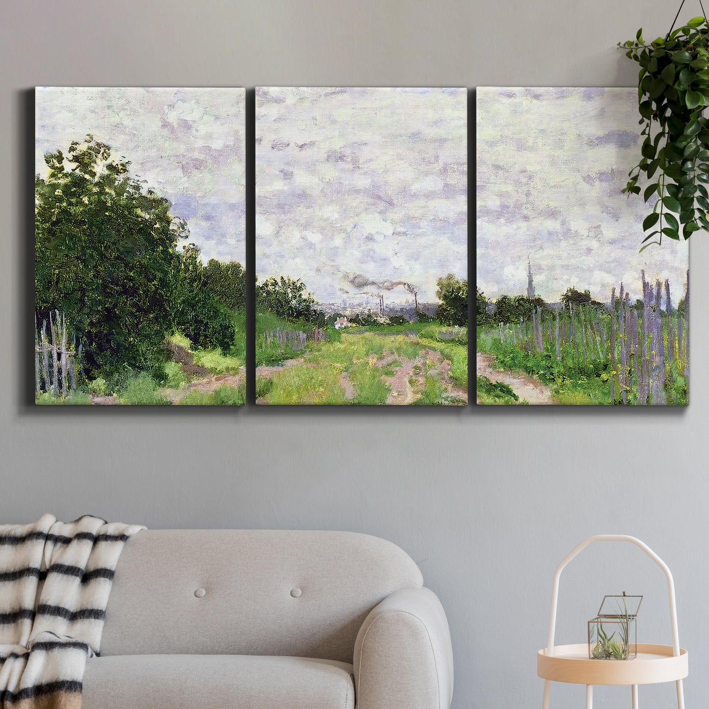 Three-panel canvas wall art featuring spring landscape with blossoming trees, displayed in a modern living room above a sofa.