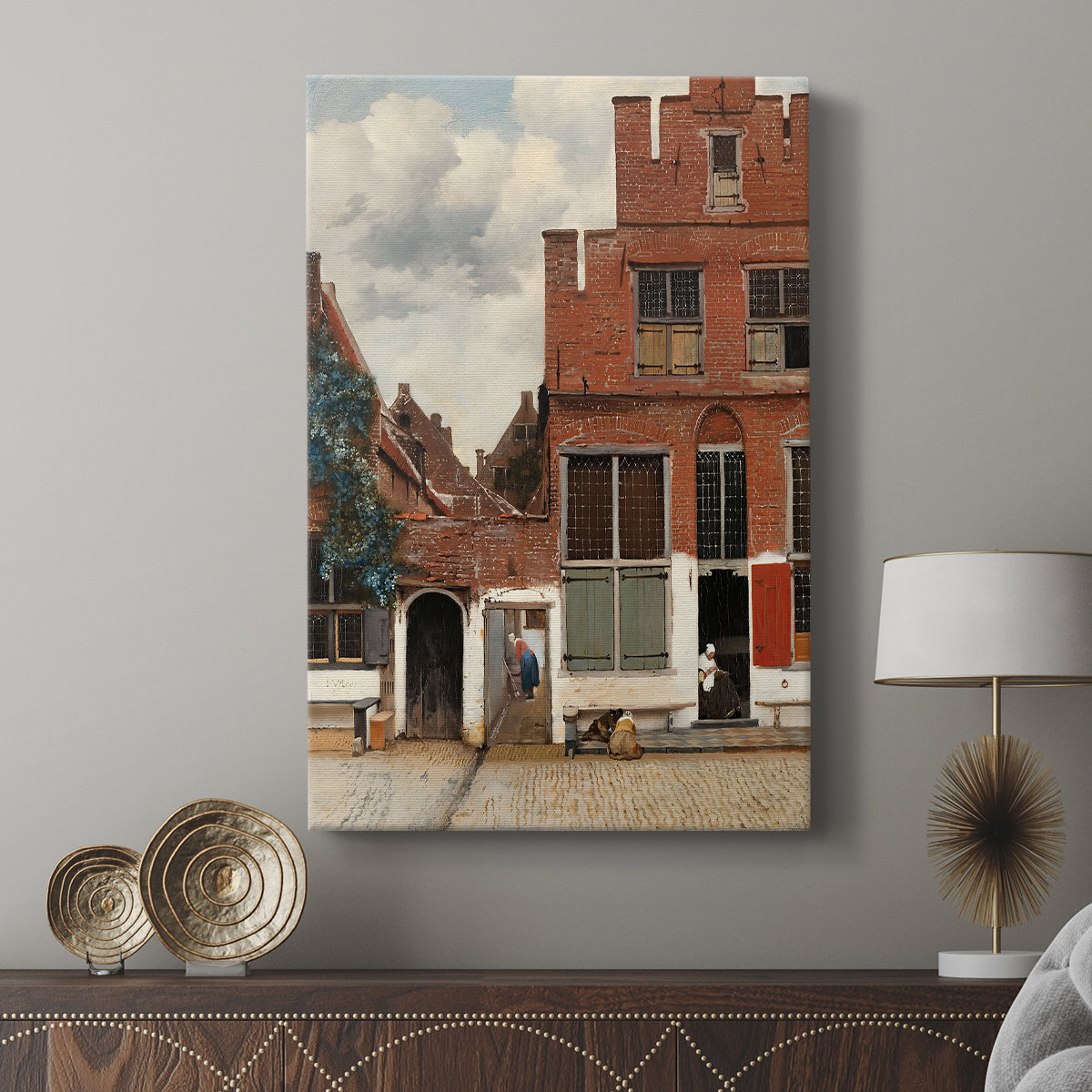 Canvas art print featuring a calm exterior scene with buildings and subtle activity displayed in a modern interior space.