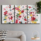Three-panel canvas wall art featuring joyful spring floral composition, displayed in a modern living room above a sofa.