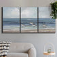 Three-panel canvas wall art featuring shore birds searching along beach, displayed in a modern living room above a sofa.