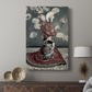 Canvas art print featuring a stylized portrait with vibrant tones and cultural motifs displayed in a modern interior space.