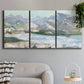 Three-panel canvas wall art featuring pastel mountain landscape view, displayed in a modern living room above a sofa.