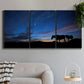 Three-panel canvas wall art featuring resting animals in open field, displayed in a modern living room above a sofa.