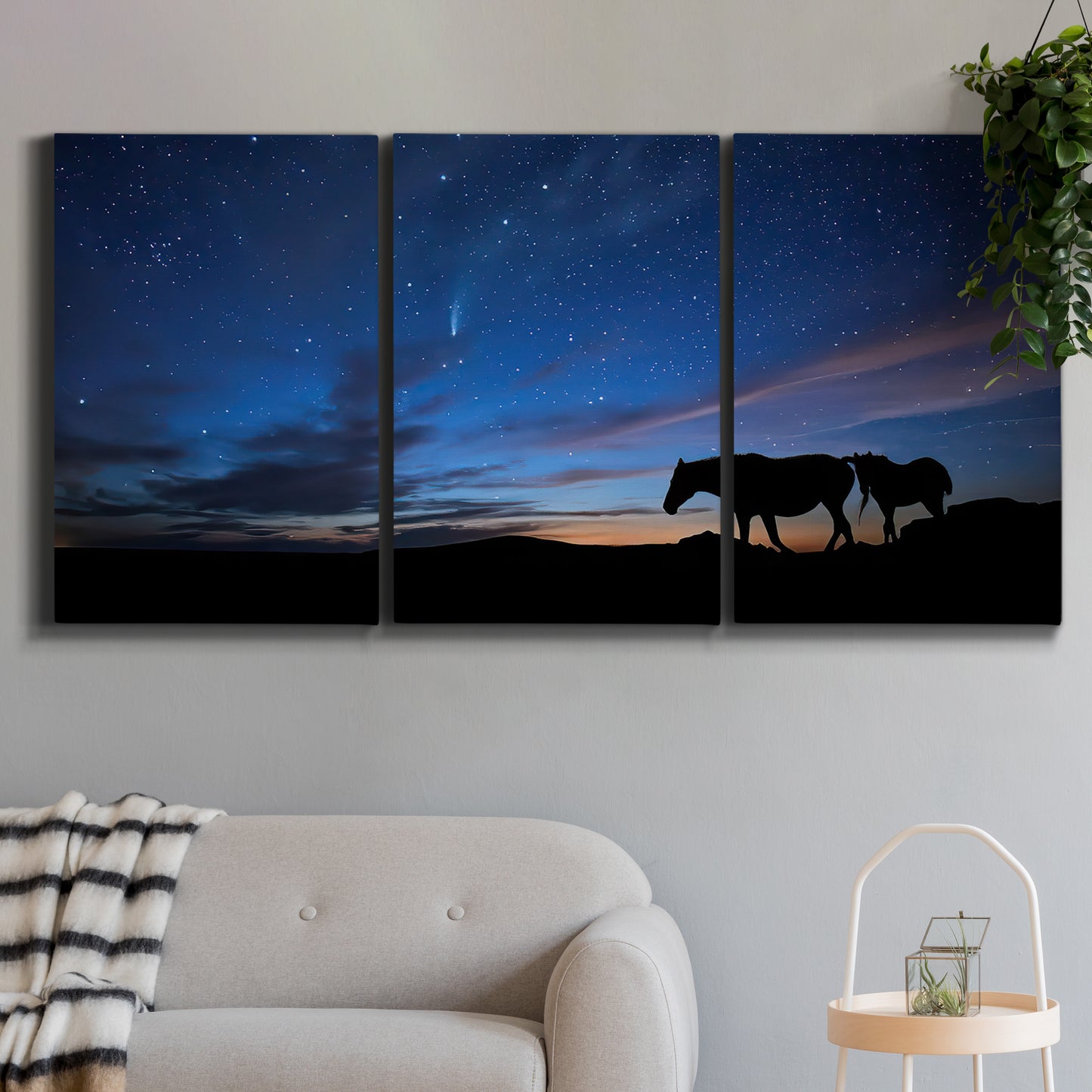 Three-panel canvas wall art featuring resting animals in open field, displayed in a modern living room above a sofa.