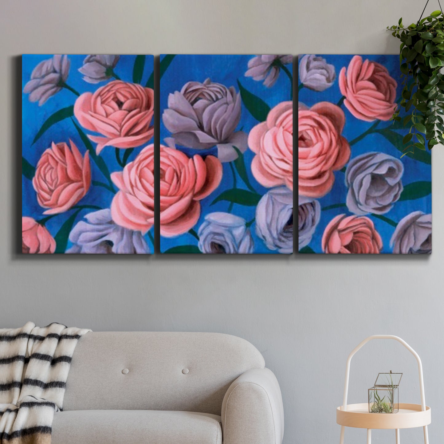 Three-panel canvas wall art featuring layered botanical petal abstractions, displayed in a modern living room above a sofa.