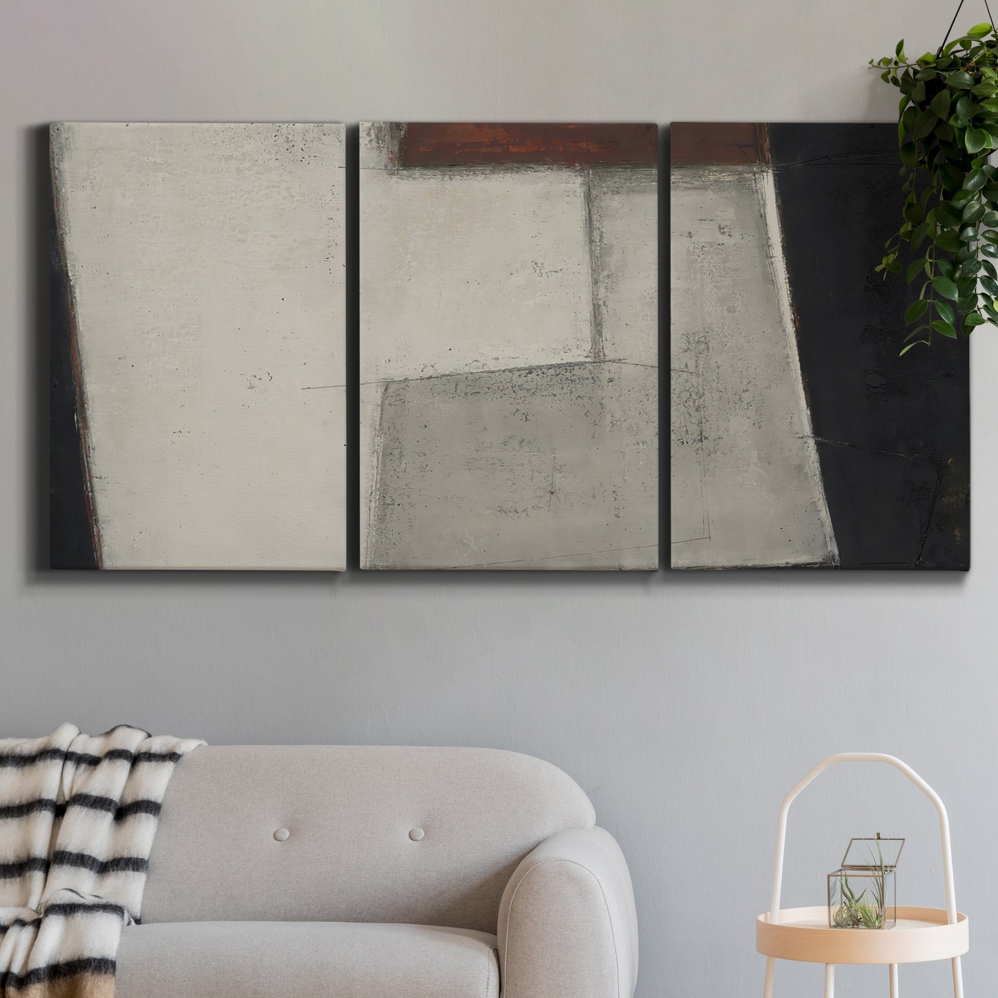 Three-panel canvas wall art featuring geometric abstract roadway motif, displayed in a modern living room above a sofa.