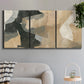 Three-panel canvas wall art featuring blurred mixed media abstract collage, displayed in a modern living room above a sofa.