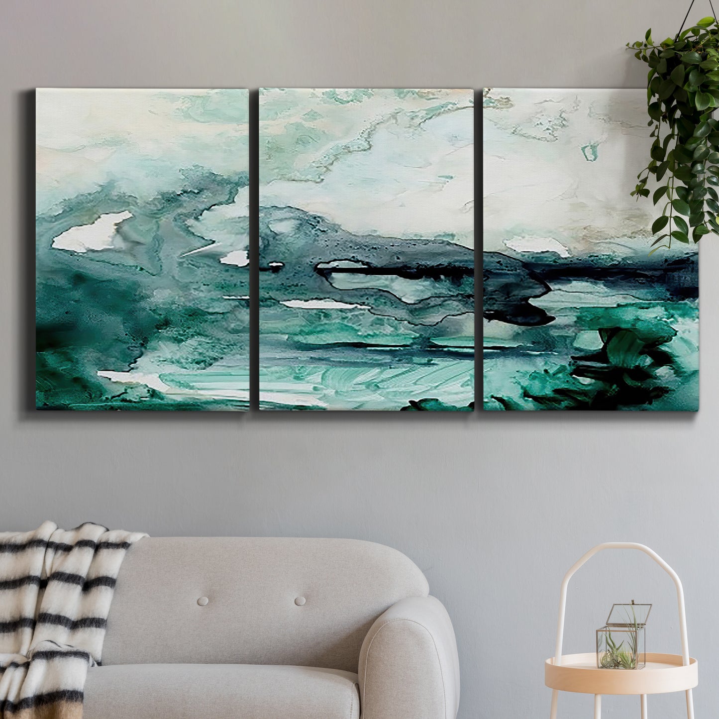 Three-panel canvas wall art featuring coastal abstract sea foam movement, displayed in a modern living room above a sofa.
