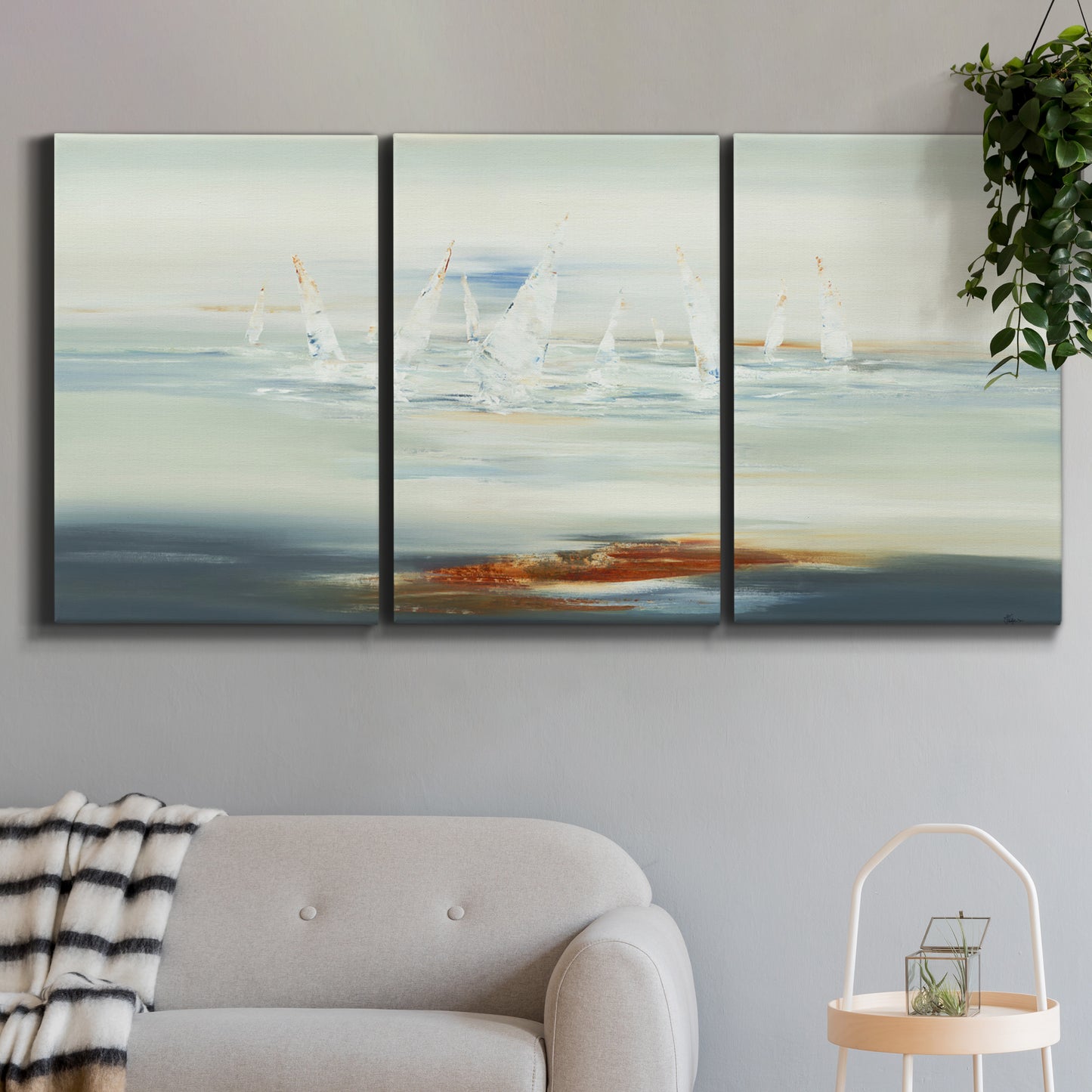 Three-panel canvas wall art featuring nautical abstract suggesting drifting calm, displayed in a modern living room above a sofa.