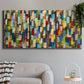 Three-panel canvas wall art featuring colorful confetti style abstraction, displayed in a modern living room above a sofa.