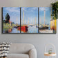 Three-panel canvas wall art featuring sailboats gathered along river, displayed in a modern living room above a sofa.