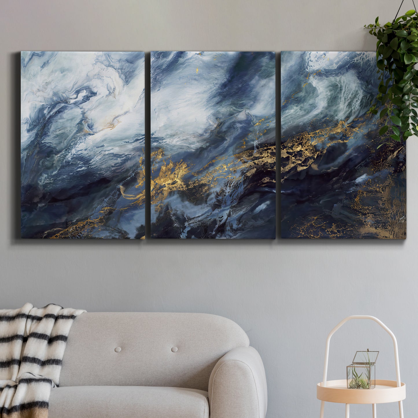 Three-panel canvas wall art featuring soft abstract landscape anticipation tones, displayed in a modern living room above a sofa.