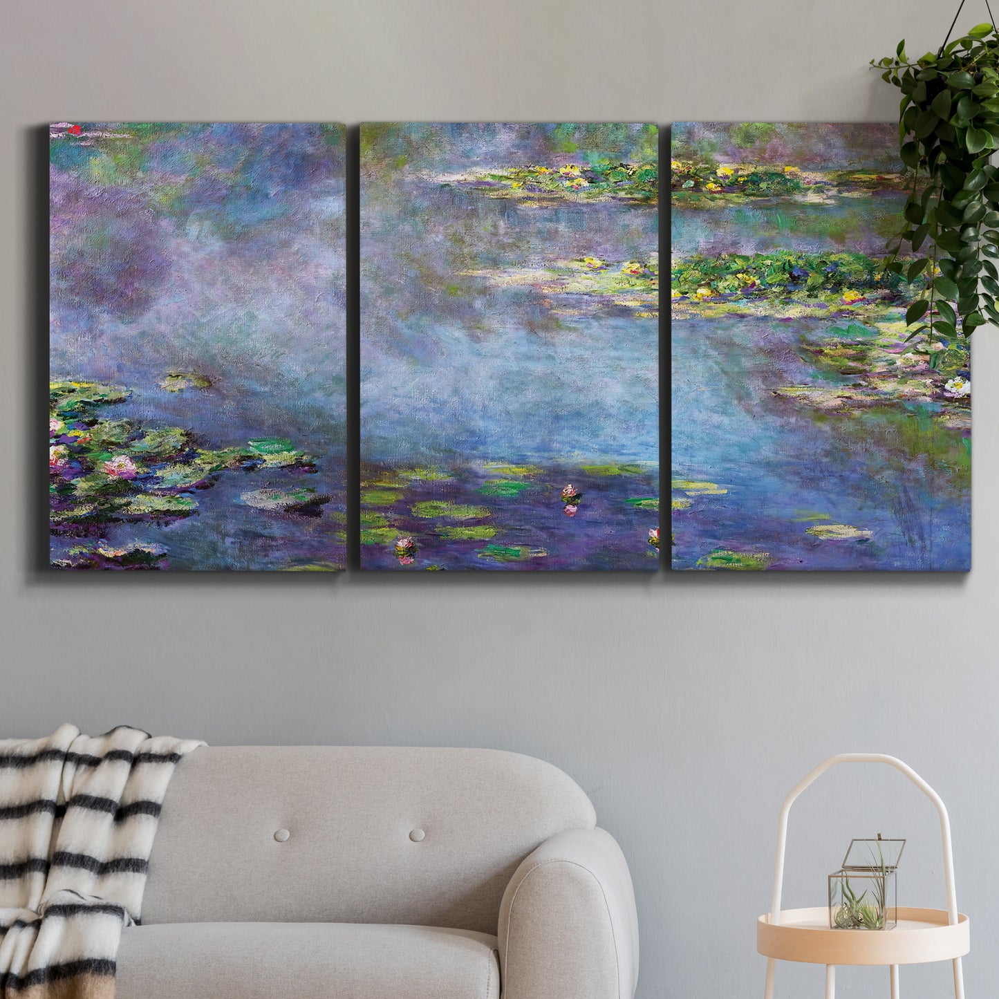 Three-panel canvas wall art featuring water lilies emerging through mist, displayed in a modern living room above a sofa.