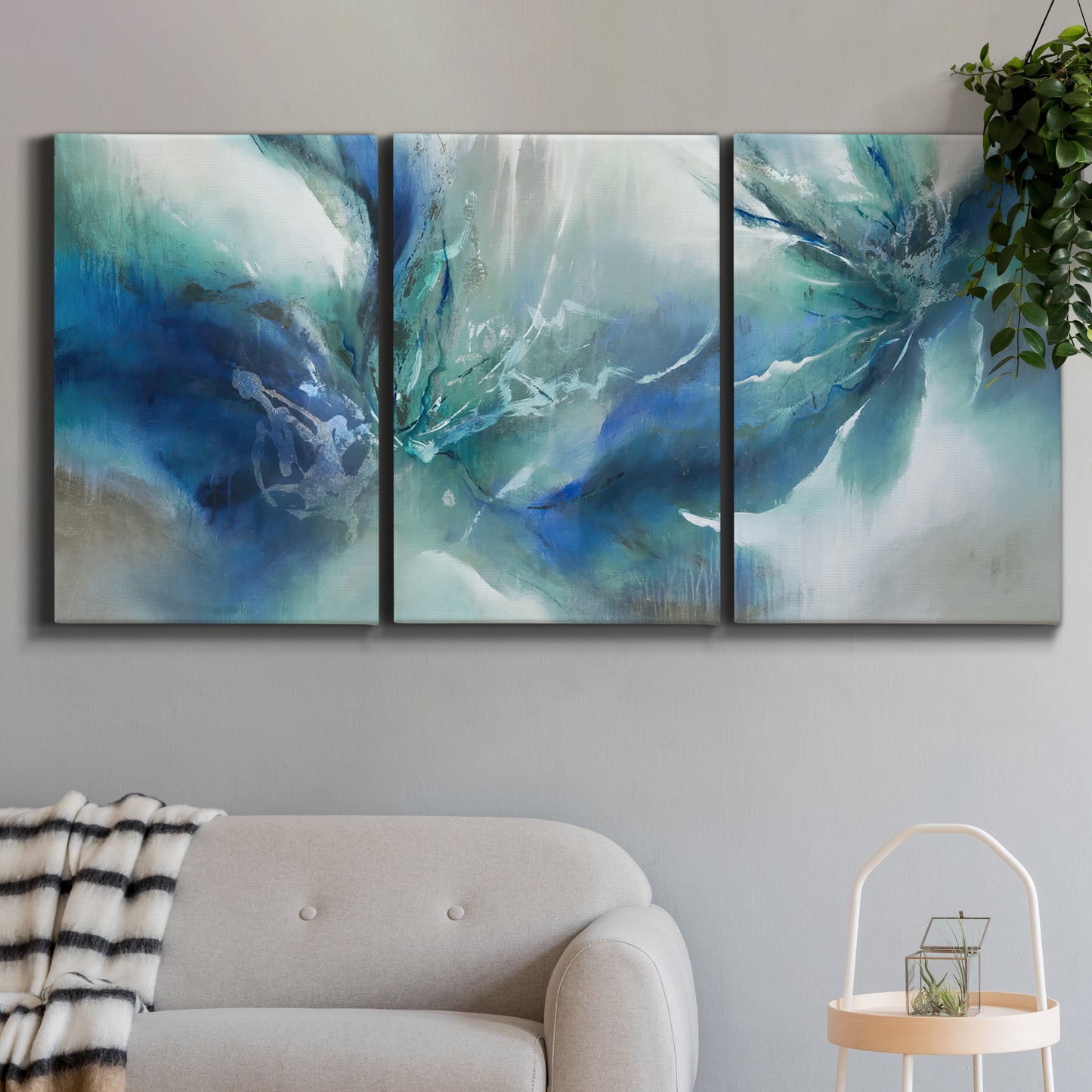 Three-panel canvas wall art featuring subtle abstract light flicker composition, displayed in a modern living room above a sofa.
