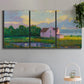 Three-panel canvas wall art featuring farmhouse near coastline landscape, displayed in a modern living room above a sofa.