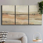 Three-panel canvas wall art featuring earth toned abstract landscape, displayed in a modern living room above a sofa.