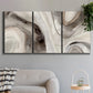 Three-panel canvas wall art featuring layered stone inspired abstract forms, displayed in a modern living room above a sofa.
