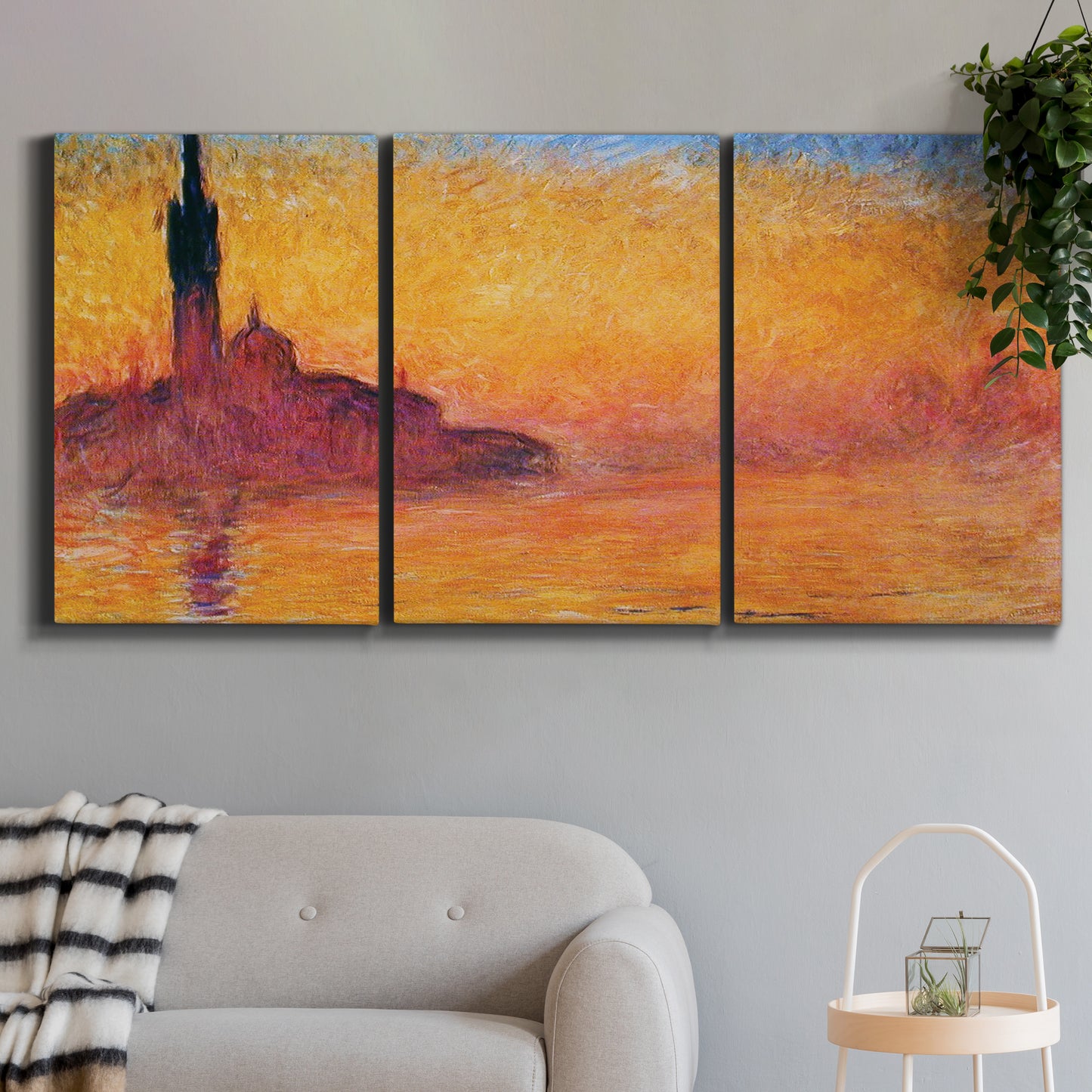 Three-panel canvas wall art featuring venetian church at twilight, displayed in a modern living room above a sofa.