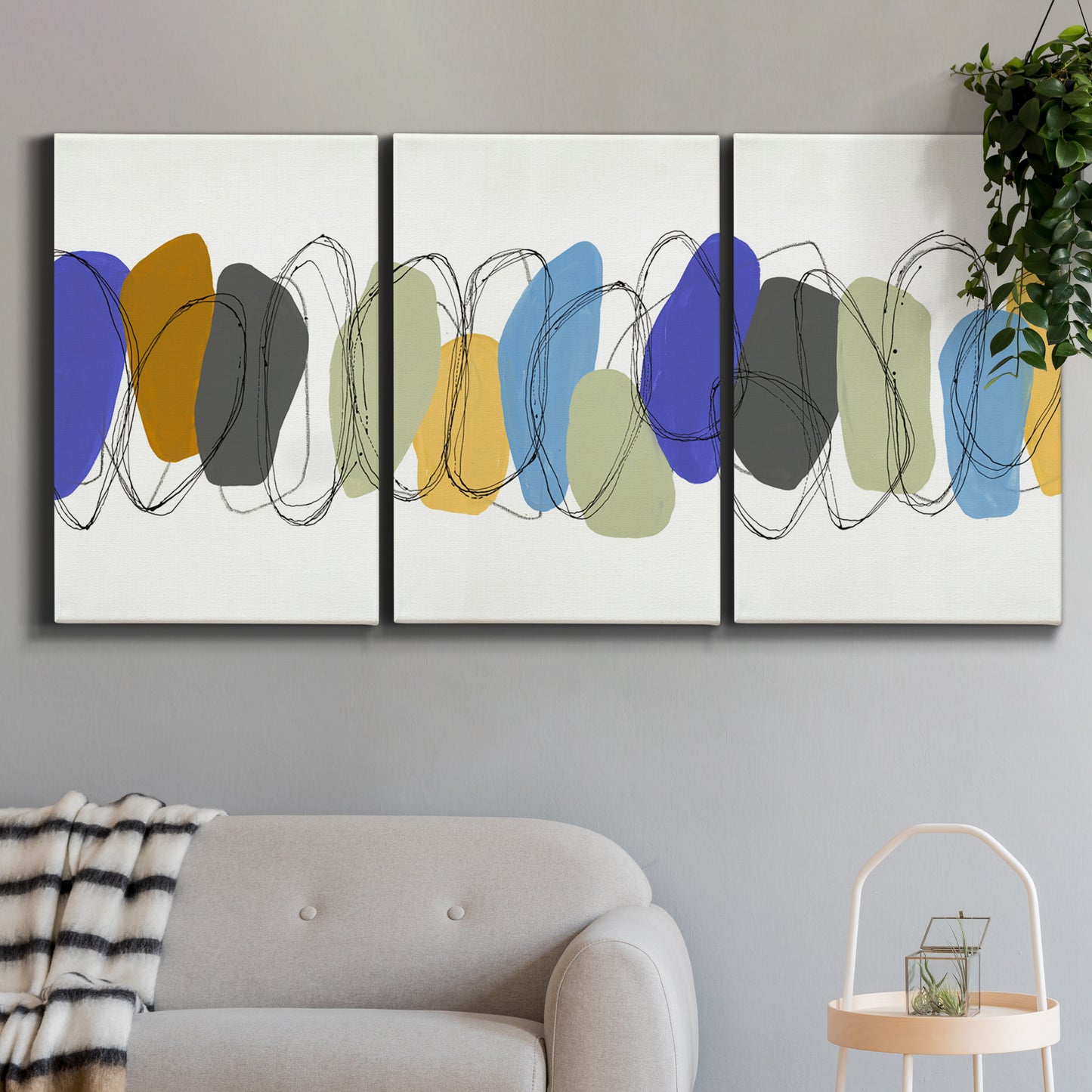 Three-panel canvas wall art featuring minimalist geometric abstract spacing, displayed in a modern living room above a sofa.