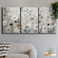 Three-panel canvas wall art featuring misty wildflower meadow landscape, displayed in a modern living room above a sofa.
