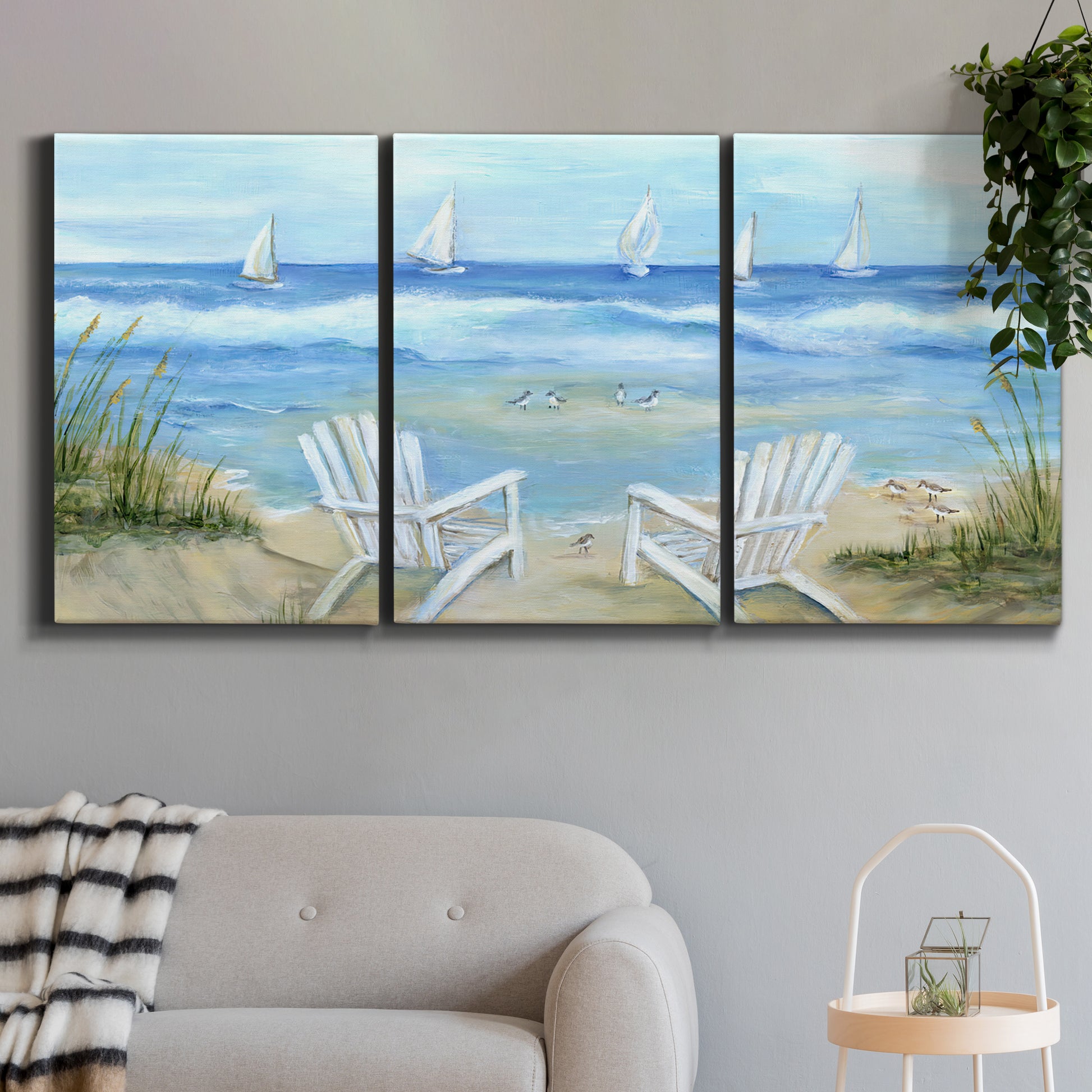 Three-panel canvas wall art featuring peaceful coastal landscape escape, displayed in a modern living room above a sofa.