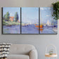 Three-panel canvas wall art featuring river flowing past riverside town, displayed in a modern living room above a sofa.
