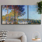 Three-panel canvas wall art featuring autumn poplar trees along river, displayed in a modern living room above a sofa.