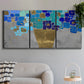 Three-panel canvas wall art featuring blue floral abstract botanical expression, displayed in a modern living room above a sofa.